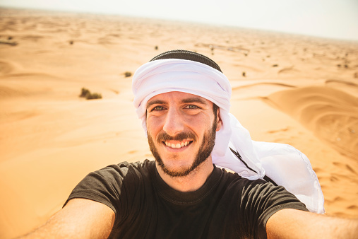 tourist man doing a selfie on the desert