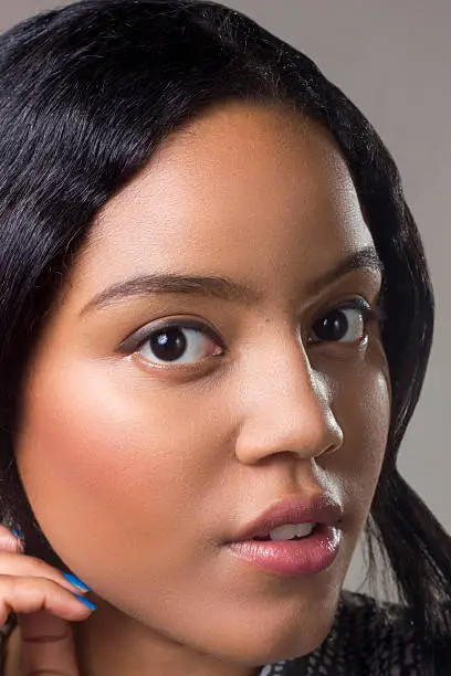 Young cute girl making facial expression in a photo studio.