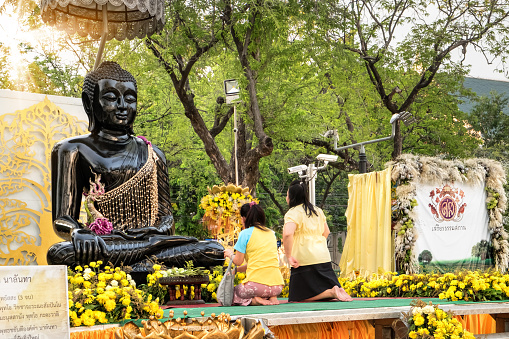 Bangkok, Thailand - December 5, 2015:Young asian women praying black Buddha, Sanam Luang, Bangkok, Thailand.