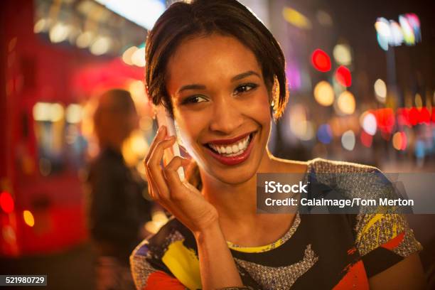 Woman Taking On Cell Phone On City Street At Night Stock Photo - Download Image Now - 25-29 Years, Adult, Adults Only
