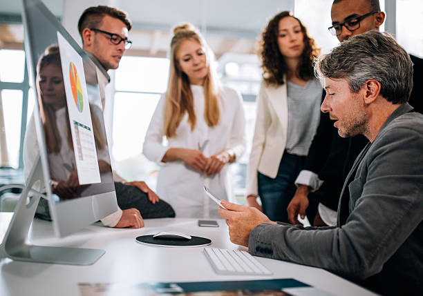 istock Multi-ethnic group having a quick team meeting at desk 521980798