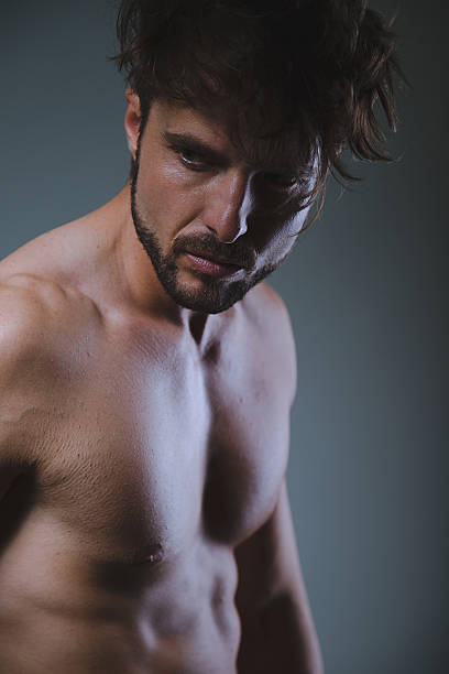 istock Fit man looking to the side seriously 521981584