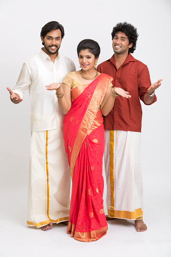 Cheerful south Indian family greeting on white background