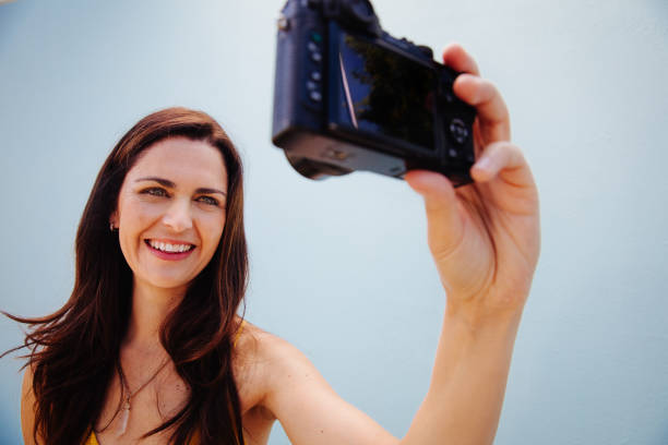 istock Woman taking selfie with retro camera 521982292