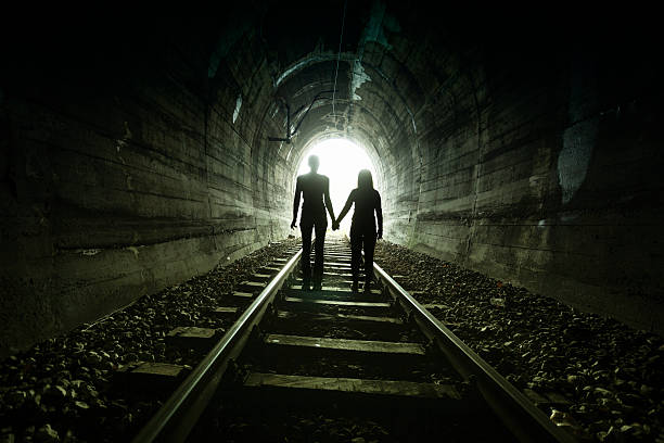istock Couple walking together through a railway tunnel 521982540