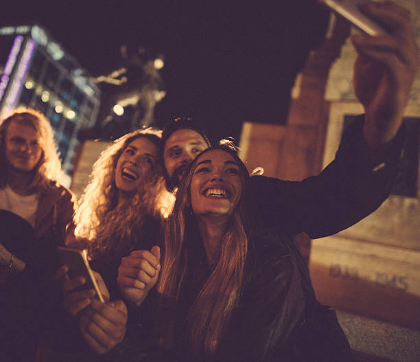 istock Hipster friends taking a night selfie in town 521982738
