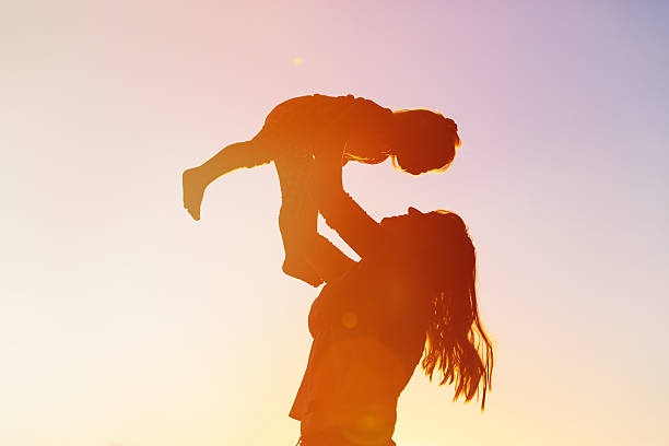 istock mother and little daughter play at sunset 521983240