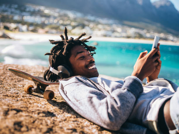 istock African American Resting, Laughing and Looking at Smartphone at 521984394
