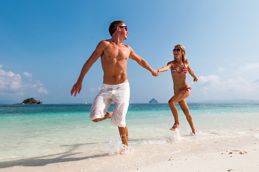 Couple running on the tropical beach
