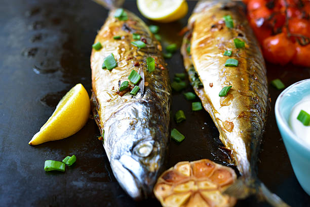 istock Grilled mackerel served with spicy yogurt dip and lemon. 521985618