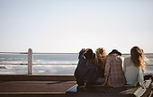 Teenager hipster styled friends watching the sea from their conv