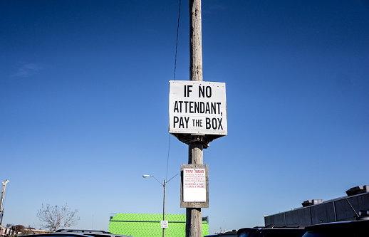 Sign to let the motorists know that the attendant may not be around all the time therefore they must pay at the box to avoid getting a parking ticket.  These signs are important so that people don't have a panic attack and have not a clue what to do.