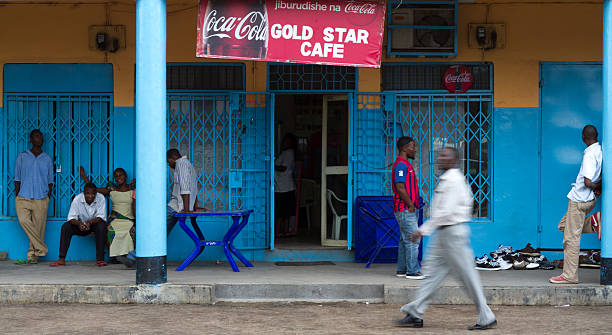 Mwanza, Tanzania: Locals Relax Outside a Colorful Cafe Mwanza, Tanzania- May 10, 2012: Locals relax outside the colorful Gold Star Cafe in central Mwanza. mwanza city tanzania stock pictures, royalty-free photos & images