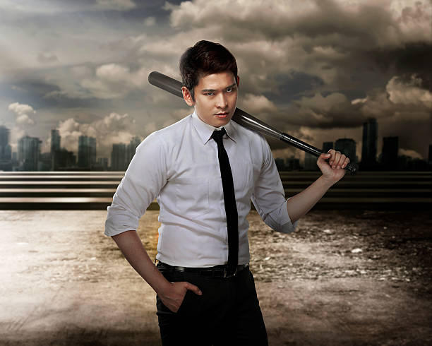 istock Man in white shirt holding baseball bat 521993898