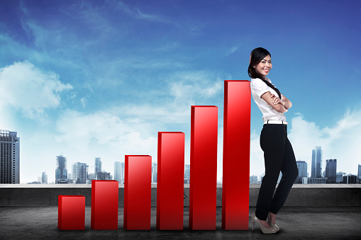 Asian business woman lean on increasing graph