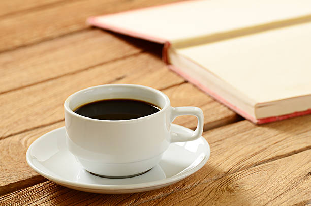 istock cup of coffee and book on wooden table 521995419
