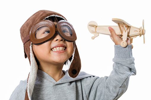 Asian Little Chinese Girl Playing with Toy Airplane in isolated White Background