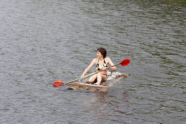 istock woman floating on a wooden raft 521996112