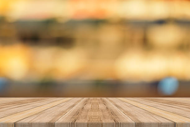 istock Wooden board empty table blur in coffee shop. 521996286