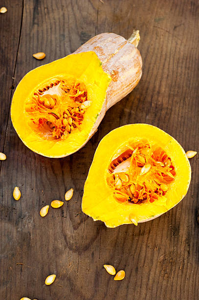 istock pumpkins cut closeup, on wooden background 521996679
