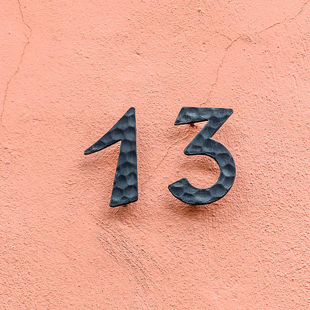 istock house number thirteen at a pink wall 521997759