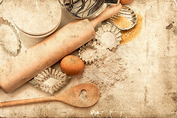 baking ingredients and tolls for dough preparation. flour, eggs, sugar, rolling pin and cookie cutters on white background. retro style picture