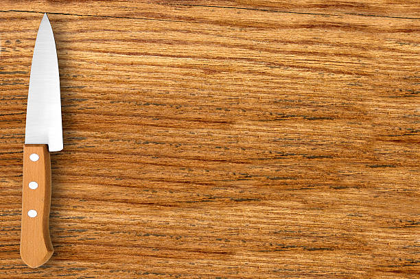 istock Kitchen knife on wooden cutting board 521999202