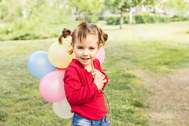 istock little girl with balloons 521999326
