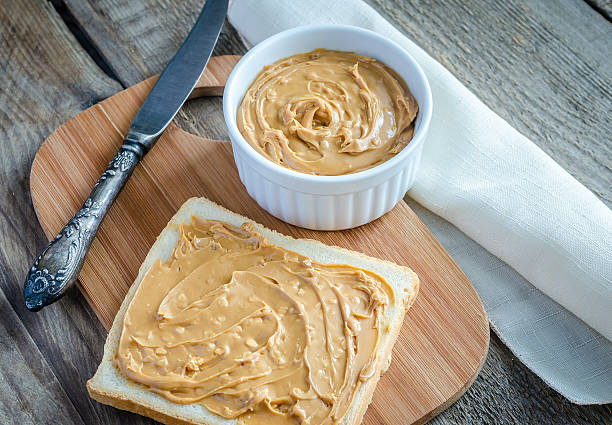 istock Sandwich with peanut butter on the wooden board 521999495