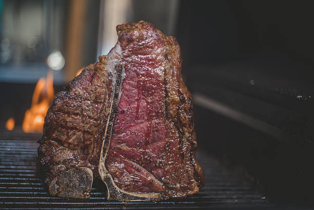 istock BBQ T-Bone Steak on Grill standing 521999568