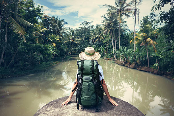 istock Woman traveler with backpack sitting on the edge 522001452