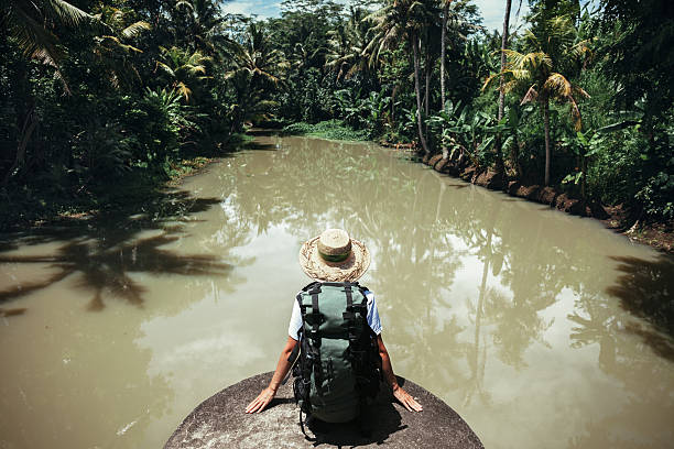 istock Young traveler woman sitting with big backpack 522002318