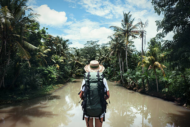 istock Traveling woman looking at tropical river 522002792