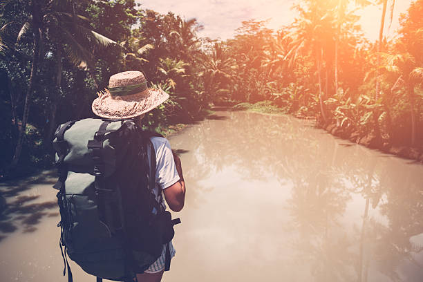istock Traveling woman looking at tropical river 522002978
