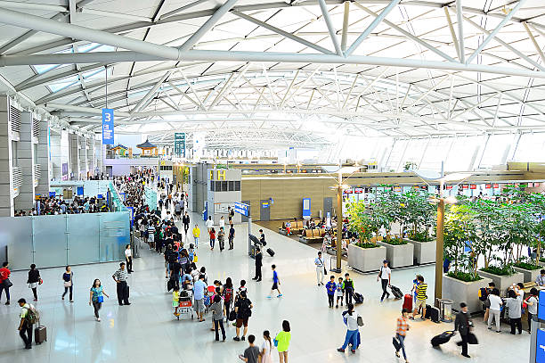 People transit the Incheon International Airport, South Korea  Incheon, South Korea - August 25, 2013: People transit the Incheon International Airport is the largest airport in South Korea, the primary airport serving the Seoul National Capital Area, in Seoul, South Korea. incheon stock pictures, royalty-free photos & images