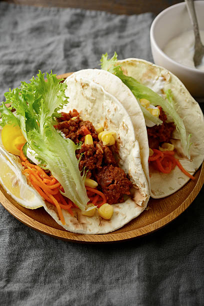 istock Two Mexican Tacos on a wooden plate 522004160
