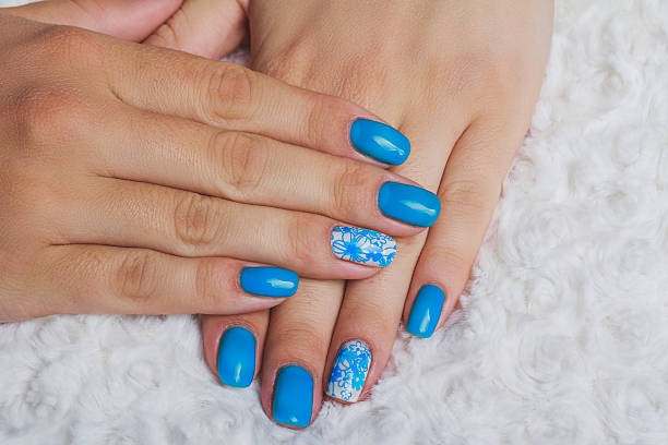 istock Light blue nail art with flowers on white textile 522006128