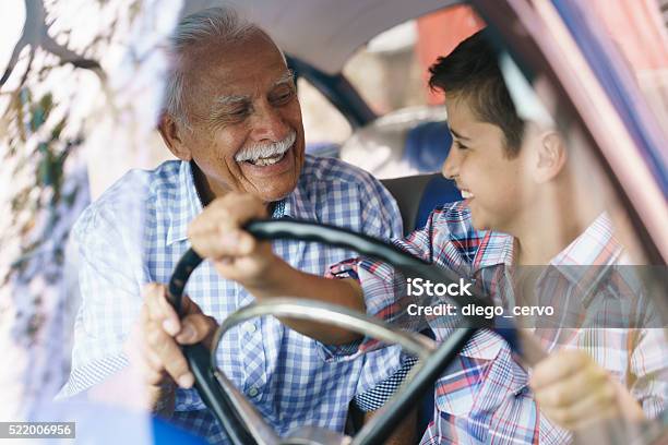 Old Man Grandpa Gives Driving Class To Grandson Stock Photo - Download Image Now - Grandfather, Latin American and Hispanic Ethnicity, Car