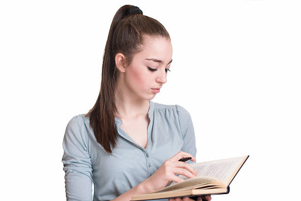 istock Young beautiful girl reading a book and thinking 522007262