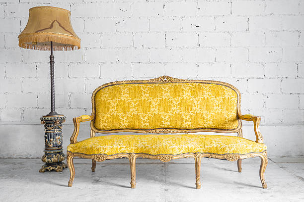 Sofa with lamp Classical style Armchair sofa couch in vintage room with desk lamp gold desk lamp stock pictures, royalty-free photos & images