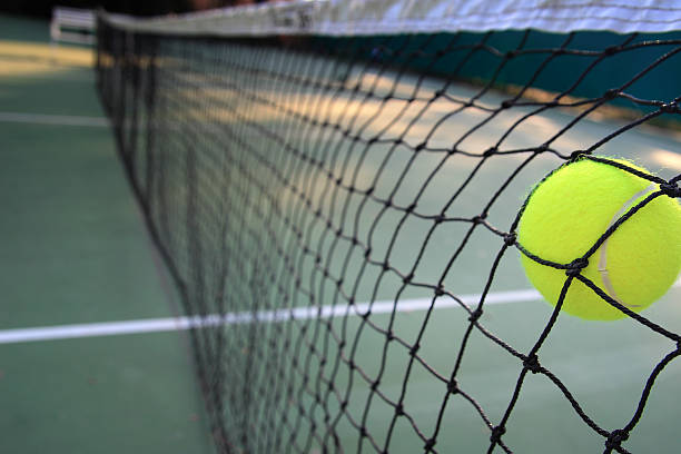 istock Tennis ball in net 522015601
