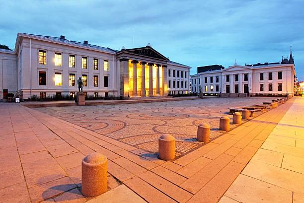 Students walk on University Square on the University of Oslo central campus in downtown Oslo Norway on a sunny morning.