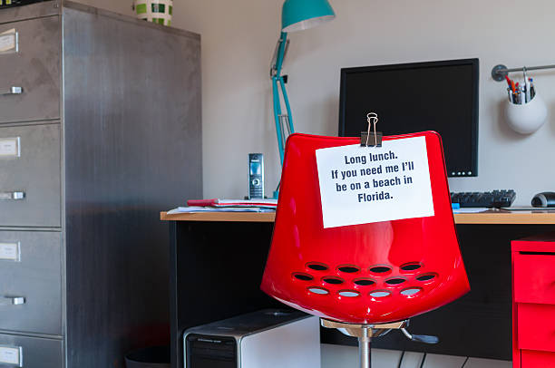 Long Lunch: On a Beach in Florida! Employee leaves note pinned to chair to tell colleagues that  if they are needed, they can be found on a beach in Florida! rat race stock pictures, royalty-free photos & images