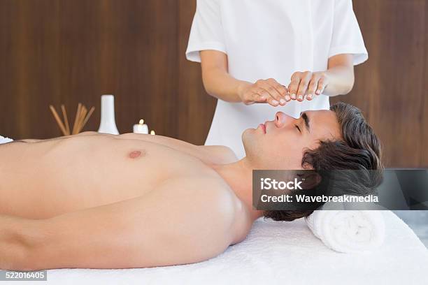 Man Receiving Treatment At Spa Center Stock Photo - Download Image Now - 20-24 Years, 20-29 Years, Adult