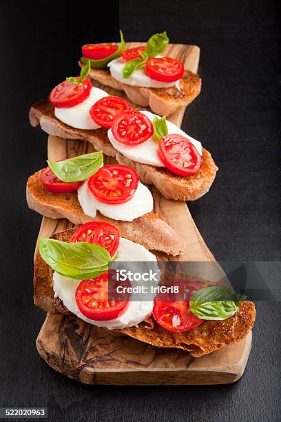 Italian Bruschetta With Cherry Tomatoes Mozzarella Fresh Basi Stock Photo - Download Image Now