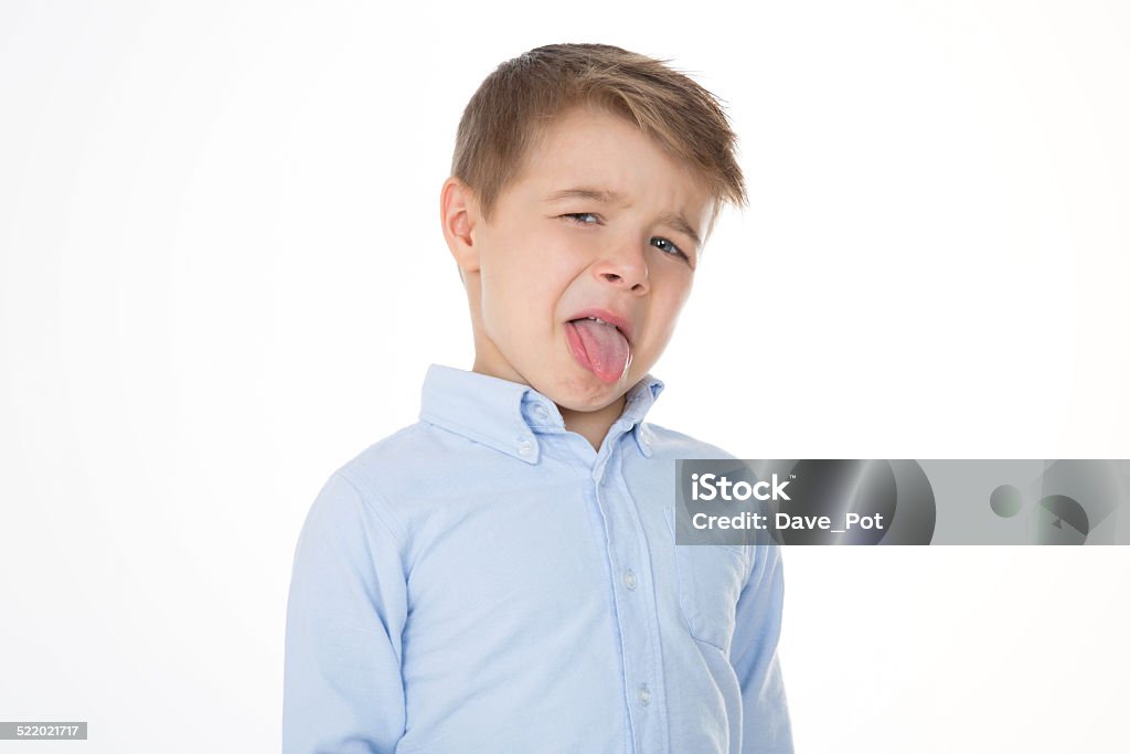 little disgusted kid boy shows his tongue Child Stock Photo