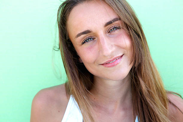 istock Happy young woman posing against green background 522031975