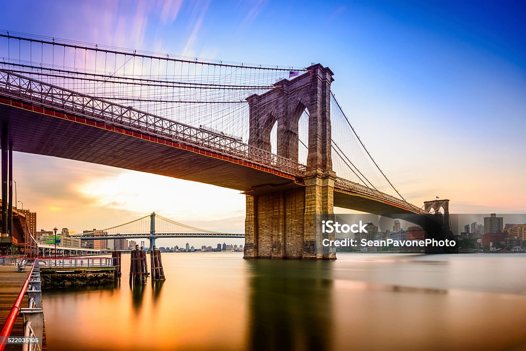 Brooklyn Bridge New York City, USA at the Brooklyn Bridge and East River at dawn. Brooklyn Bridge Stock Photo