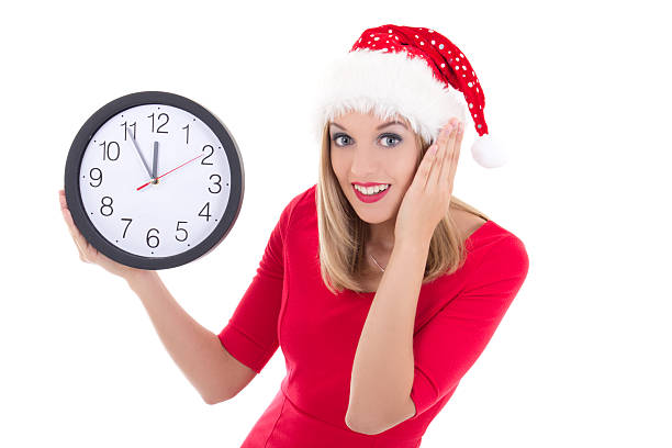 istock surprised woman in santa hat with clock posing 522035219