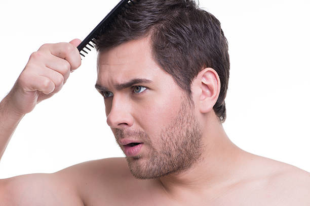 istock Happy young man combing hair. 522035341